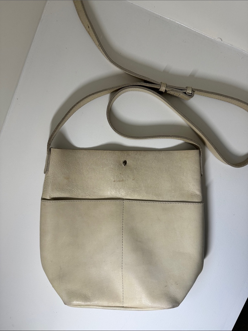 Able cream leather shoulder bag with adjustable strap.